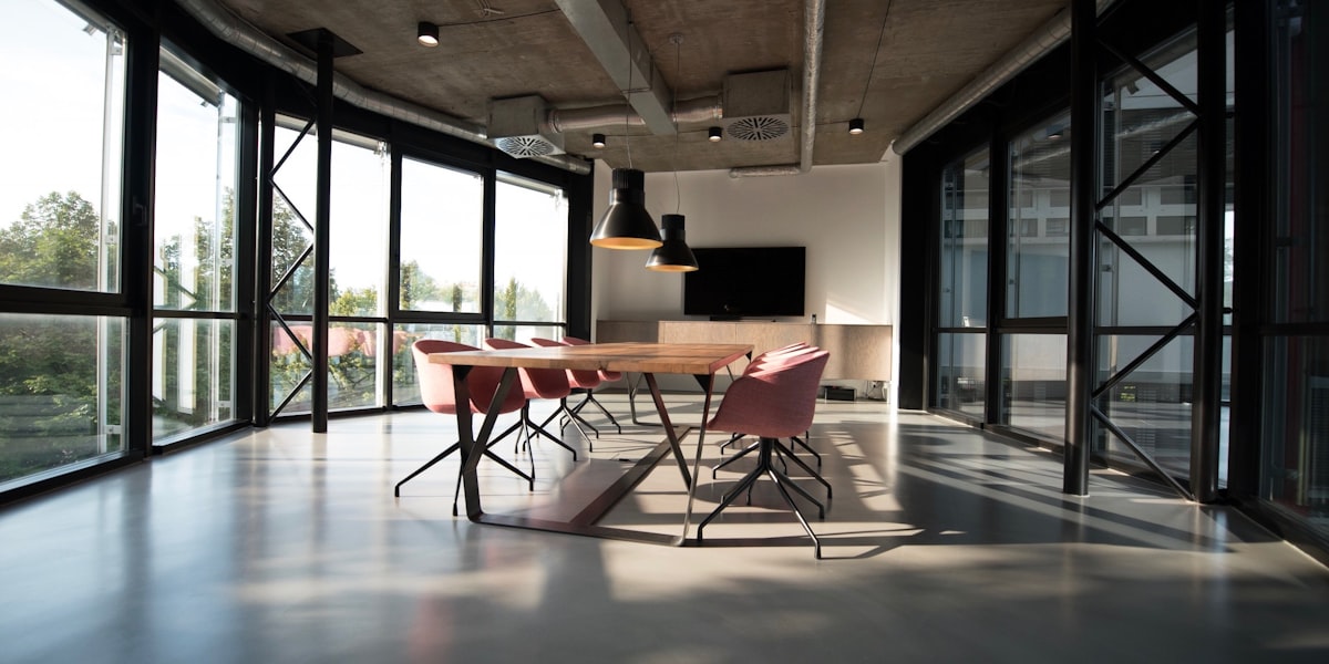 Empty modern conference room, representing quiet headcount reductions at smaller companies