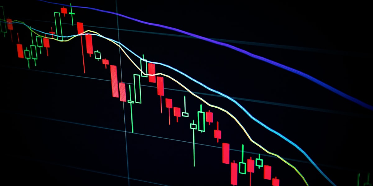 Falling red candlestick chart on a dark trading screen, representing the deepening Nifty IT sell-off